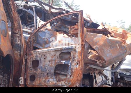 Autofriedhof. Verbrannte und gesprengte Autos. Autos beschädigt nach Beschuss durch russische Invasion. Krieg zwischen Russland und der Ukraine. Terroranschlag Bombe Shell. Katastrophengebiet irpin bucha. Stockfoto