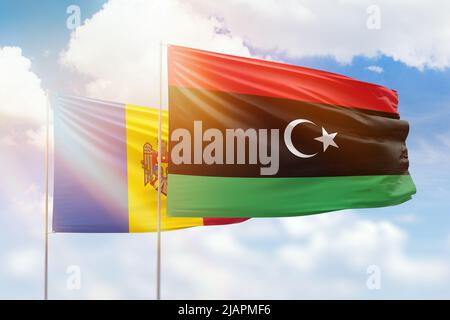 Sonniger blauer Himmel und Flaggen von libyen und moldawien Stockfoto