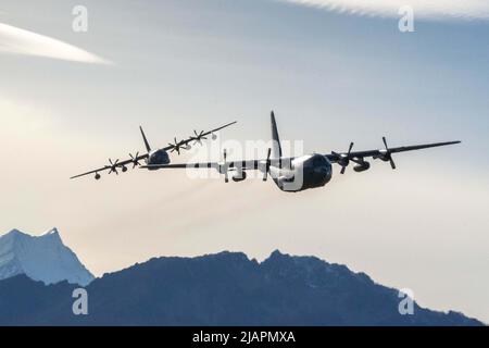 RNZAF Base Auckland, Neuseeland. 13.. Mai 2022. Ein C-130H Herkules, der der Royal New Zealand Air Forces 40 Squadron, rechts, zugewiesen wurde, und ein MC-130J Commando II der US Air Force, der dem 353. Special Operations Wing, links, zugewiesen wurde, fliegen in einer unähnlichen Formation über Neuseelands South Island im Rahmen der Übung Teak Net 22, 13. Mai 2022. Unterschiedliche Ausbildung verbessert die Fähigkeit der einzelnen Mitglieder der Luftbesatzung, eng mit verschiedenen Luftframes zu arbeiten, was die Fähigkeiten der Luftstreitkräfte beider Nationen verbessert. Quelle: U.S. Air Force/ZUMA Press Wire Service/ZUMAPRESS.com/Alamy Live News Stockfoto