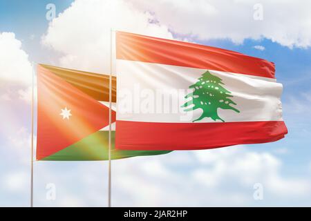 Sonniger blauer Himmel und Flaggen von libanon und jordanien Stockfoto