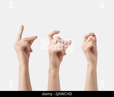 Satz weiblicher Hand, die die Fingerbewegung auf weißem Hintergrund abknipst. Stockfoto
