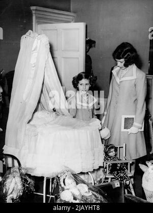 Prinzessinnen sehen ihr eigenes Kinderbett auf der Ausstellung -- Prinzessin Elizabeth (rechts ***** Prinzessin Margaret Rose beim Betrachten des ***** Beide werden als Babys verwendet und das ist jetzt ***** War früher ihre Kinderstube. Prinzessin Elizabeth und Prinzessin Margaret Rose besuchten ihr altes Haus. No.145, Piccadilly, Londoner Residenz des Königs und der Königin als Herzog und Herzogin von York, um die Ausstellung der königlichen und historischen Schätze zu sehen, zu der sie zusammen mit anderen Mitgliedern der königlichen Familie Exponate beisteuerten. Die Königin besuchte vor kurzem die Ausstellung mit dem König und war so beeindruckt, dass sie entschied, dass die Princesse Stockfoto