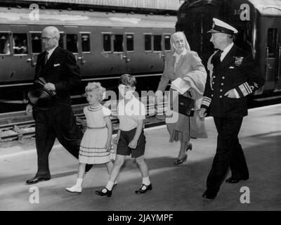 Royal Children Kommen In Portsmouth An -- Prinz Charles und seine Schwester, Prinz Anne, gefolgt von ihrer Großmutter, Prinzessin Andrew von Griechenland, und begleitet von Vizeadmiral Conolly Abel Smith, Flaggenoffizier Royal Yachts, und Stationmaster Mr. T. Fryer, gehen aus dem Zug nach der Ankunft in Portsmouth heute (Freitag) von London, um in die Royal Yacht Britannia zu besteigen. Sie werden sich mit ihren Eltern, der Queen und dem Herzog von Edinburgh, auf einer achttägigen Kreuzfahrt treffen, während der das Königspaar Verpflichtungen in Wales, der Isle of man und Schottland erfüllen wird. 05. August 1955. Stockfoto