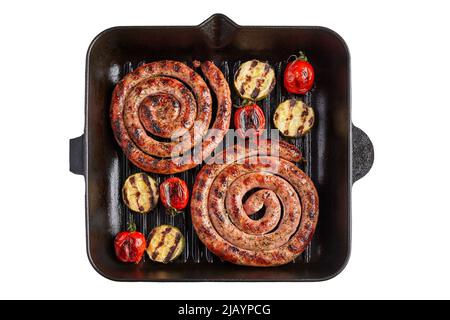 Spiralwürste Tomaten und Zucchini auf einer Grillpfanne auf einem weißen Teller Stockfoto