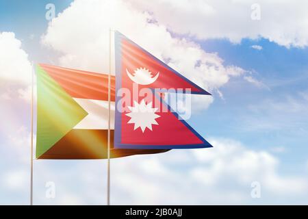 Sonniger blauer Himmel und Flaggen von nepal und sudan Stockfoto