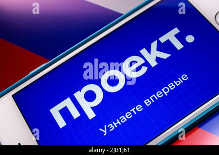 Kumamoto, JAPAN - Jul 19 2021 : Logo von Proekt Media, einem russischen Medium, das sich auf investigativen Journalismus spezialisiert hat, auf dem iPhone auf russischer Flagge Stockfoto