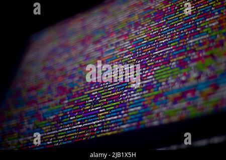 Farbenfroher Code-Hintergrund. Komprimierter javascript-Code auf dem Computerbildschirm. Bildschirm für die Codierung von Softwareentwicklern Stockfoto