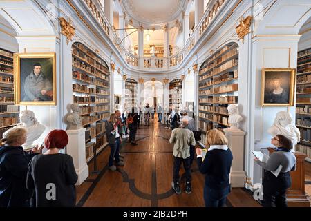 Weimar, Deutschland. 02.. Juni 2022. Besucher besichtigen den Rokoko-Saal der Herzogin Anna Amalia Bibliothek. Mit der neuen Dauerausstellung „Cranachs Bilderfluten“ zeigt die Klassik Stiftung Weimar im Renaissance-Saal der Bibliothek viele Exponate aus ihrer bedeutenden Cranach-Sammlung. Die Ausstellung beginnt am 4. Juni. Ergänzend dazu steht die Weimar App zur Verfügung, die einen neuen Rundgang durch die Rokoko-Halle und Informationen zu den Exponaten der Ausstellung bietet. Quelle: Martin Schutt/dpa/Alamy Live News Stockfoto