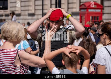 Mitglieder der Royal Military Police (RMP) unterstützen die Öffentlichkeit beim Zugang zur Mall, um sich am 1.. Juni 2022 in London, England, das Trooping der Farbe anzusehen, das mit dem Platin-Jubiläum der Königin zusammenfiel. Königin Elizabeth II. Steht seit 70 Jahren auf dem britischen Thron, die dienstälteste Monarchin der englischen Geschichte und Menschenmengen strömten nach Zentral-London, um dieses jährliche Ereignis während des Jubiläumswochenendes zu sehen. Zehntausende konnten jedoch keine der zeremoniellen Veranstaltungen sehen, da die Mall von der Polizei für mehr Besucher geschlossen wurde und stattdessen in den umliegenden Straßen und in Trafalgar blieb Stockfoto