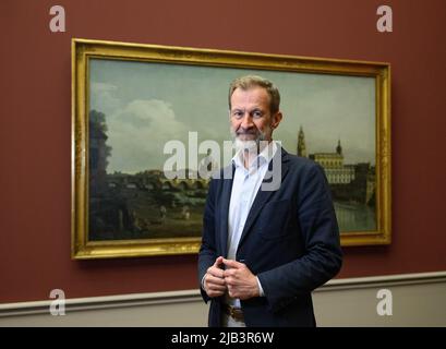 05. Mai 2022, Sachsen, Dresden: Stephan Koja, Direktor der Gemäldegalerie und Skulpturensammlung der Alten Meister bis 1800, Steht vor dem Gemälde 'Dresden vom rechten Elbufer unterhalb der Augustusbrücke' von 1748 während der Bauarbeiten für die Ausstellung 'Magie der Real - Bernardo Bellotto am Sächsischen Hof' in den Alten Meistern. Mit der Schau vom 21. Mai bis 28. August 2022 feiern die Staatlichen Kunstsammlungen den 300.. Geburtstag des venezianischen Künstlers Bernardo Bellotto (1722-1780), der sich Canaletto nannte. Foto: Robert Michael/dpa Stockfoto