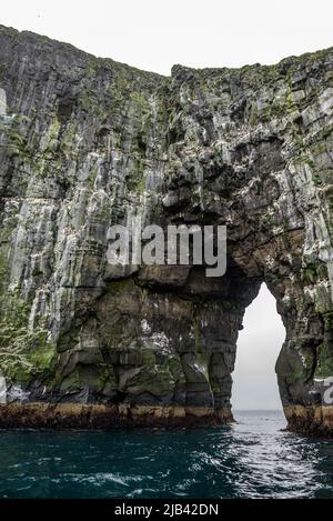 Arch of Stori Drangur of Drangarnir Felsformation auf der Insel Vagar von einem Boot aus gesehen, Färöer-Inseln Stockfoto