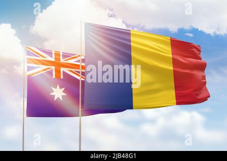 Sonniger blauer Himmel und Flaggen von rumänien und australien Stockfoto