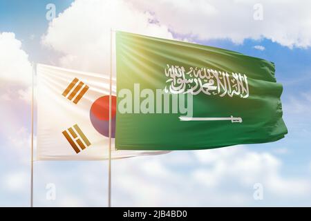 Sonniger blauer Himmel und Flaggen von saudi-arabien und Südkorea Stockfoto