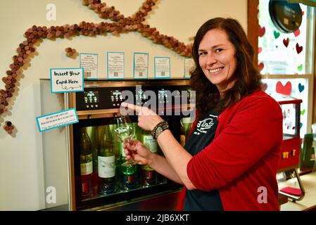 Sommelier und Besitzer Jaclyn Stuart gießt Wein aus dem automatischen Weinausgabesystem Wine-E-Motion, at Vintage, Elkhart Lake, WI, USA Stockfoto