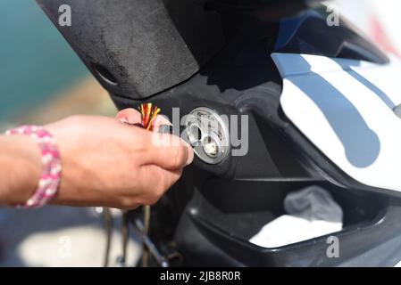 Von Hand den Zündschlüssel des Motorrads drehen Stockfoto