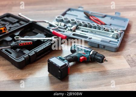 Box mit Elektroinstallateur auf Holzhintergrund. Stockfoto