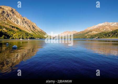 Im September geht die Sonne im herrlichen Plaun da Lej unter, einer berühmten Schweizer Bucht am Silbersee im oberen Engadintal (Grisons, Schweiz). Stockfoto