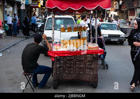 Damaskus, Syrien - Mai, 2022: Straßenverkäufer, der Maisjause verkauft Stockfoto