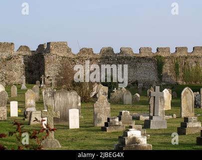 Friedhof an der Norman Church auf dem Gelände von Portchester Castle, einer mittelalterlichen Festung in Portchester, Fareham, Hampshire, England, Großbritannien Stockfoto