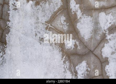 Rissige Textur an der Betonwand Stockfoto