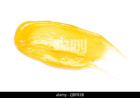 Klare transparente gelbe Gesicht Creme verschmieren, goldenen Zucker Honig isoliert auf weißem Hintergrund Draufsicht. Stockfoto