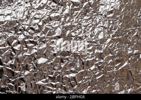 Abstrakter Metallfolie Hintergrund, Silberfolie Hintergrund. Silberne Textur Stockfoto