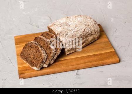 Auswahl an frisch geschnittenem Brot mit Serviette auf rustikalem Tischbild. Gesundes ungesäuertes Brot. Französische Brotscheibe. Stockfoto