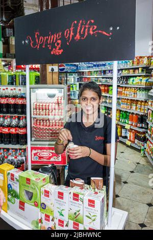 Mumbai Indien, Colaba Bhandar, Sahakari, Lebensmittelgeschäft Supermarkt innen Markt, Display Verkauf Typhoo Green Tea Frau weiblich mit kostenlosen Probe Stockfoto