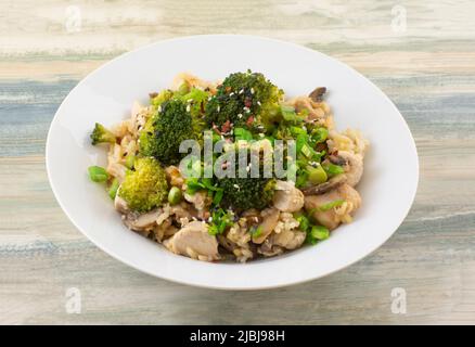 Chicken Teriyaki mit Brokkoli und Sesam mit Reis in einer weißen Schüssel Stockfoto