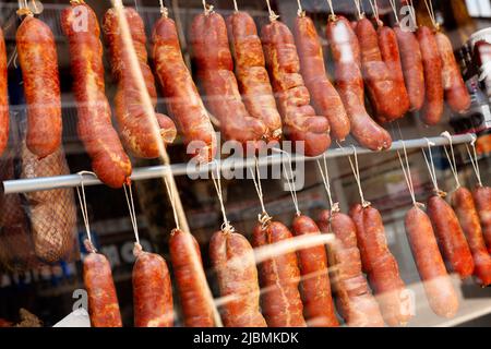 Trocken gehärtete traditionelle spanische Wurst hängen in einem Geschäft Stockfoto