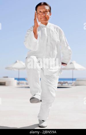 Victor, ein Tai-Chi-Lehrer, ruft im Rahmen des Ara-Rituals Billy, den Papagei, an – eines von mehreren täglichen Ritualen, die im Live Aqua Resort stattfinden Stockfoto