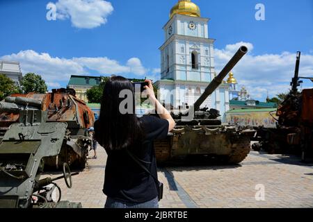 Kiew, Ukraine. 07.. Juni 2022. Das Mädchen fotografiert zerstörte russische Militärausrüstung, die im Zentrum von Kiew ausgestellt ist. In der ukrainischen Hauptstadt wird eine Ausstellung verbrannter russischer Panzer und anderer gepanzerter Fahrzeuge fortgesetzt, um die Aufmerksamkeit auf den Krieg in anderen Teilen des Landes zu lenken. Kredit: SOPA Images Limited/Alamy Live Nachrichten Stockfoto