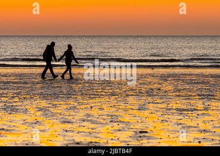 Frankreich, Somme, Ault, Paar am Strand bei Sonnenuntergang Stockfoto