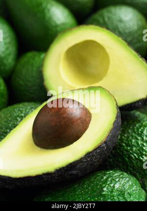 Avocadohälften ruhen auf ganzen Avocados Stockfoto