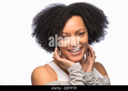 Portrait of African American young woman looking at camera with hands up framing face Stockfoto