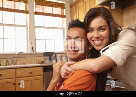 Lächelnde paar umarmt in Küche Stockfoto