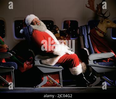 Weihnachtsmann, Rentiere und Geschenke im Flugzeug Stockfoto