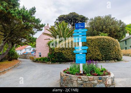 Blauer Wegweiser im Hafen mit Anweisungen zu den Attraktionen von Herm, einer Insel in der Bailiwick von Guernsey, Kanalinseln, Großbritannien Stockfoto