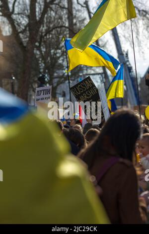 Die Teilnehmer treffen sich während des ‘Standes mit der Ukraine!’ Protest zur Unterstützung des Landes in der Nähe der Downing Street im Zentrum von London. Stockfoto