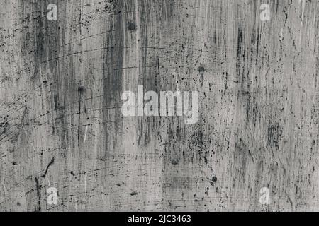 Grunge abstrakt schöne monochrome schwarz-graue Wand mit Rissen und spritzerer schwarzer Farbe auf Putz. Hintergrund mit Platz für Text oder Bild. Die Kunst der groben stilisierten Textur. Stockfoto