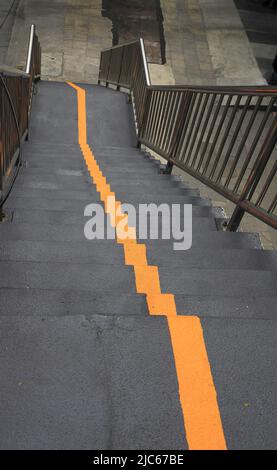 Gelbe Linie auf der Treppe der Fußgängerüberführung. Stockfoto