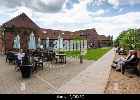 Doddington Hall ist von außen ein elisabethisches Wunderhaus oder Herrenhaus mit ummauerten Innenhöfen und einem Giebelhaus. Im Inneren wurde es im Jahr 1760s weitgehend aktualisiert. Es befindet sich im Dorf Doddington, westlich der Stadt Lincoln in Lincolnshire, England. Die Halle und die Gärten sind für die Öffentlichkeit zugänglich und bieten Einrichtungen für private Führungen und Schulbesuche. In den Gärten steht ein von Anthony Jarvis 1973 entworfener Tempel.in der Long Gallery finden Sommerkonzerte und gelegentliche Ausstellungen statt. Auf dem Anwesen wurden weitere Geschäfte entwickelt. Stockfoto