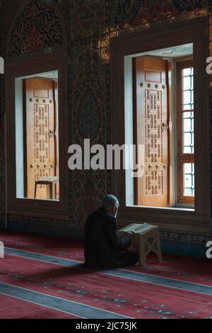 Islamisches Foto. Ein alter muslimischer Mann, der in der Moschee den Koran liest. Ramadan oder kandil oder Laylat al-qadr oder kadir gecesi oder vertikales Foto mit islamischem Hintergrund Stockfoto