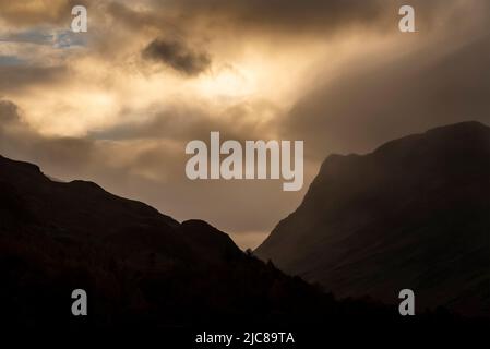 Atemberaubendes Landschaftsbild von Buttermere im Lake District bei Sonnenaufgang im Herbst mit dramatischem stürmischen Himmel Stockfoto