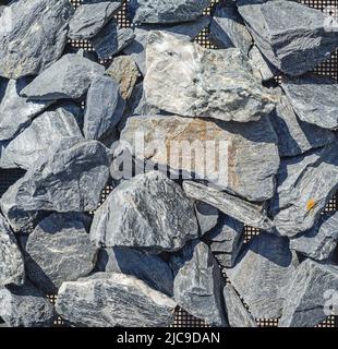 Große Trümmer. Grauer Stein für den Bau. Baustelle. Zerkleinerter Stein. Verkauf von Steinen Stockfoto