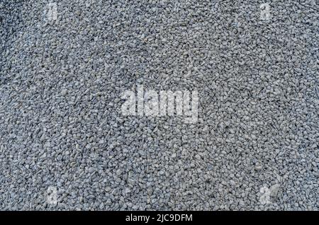 Abstrakte Steinstruktur. Feiner grauer Kies. Kleine graue Steine. Baumaterial Stockfoto