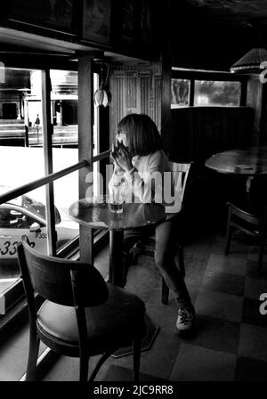 Eine Frau genießt ein Pint Bier im Vesuvio Cafe, einer bekannten Bar in San Francisco, Kalifornien, die von Mitgliedern der Beat Generation 1950s besucht wird. Stockfoto