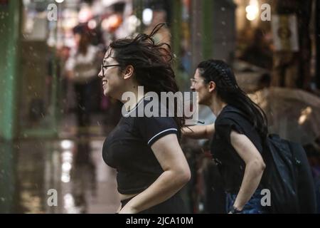 Ankara, Türkei. 11.. Juni 2022. Zwei Frauen werden vor dem Regen weglaufen gesehen. In Ankara, der Hauptstadt der Türkei, fallen heftige Regenfälle. (Foto von Tunahan Turhan/SOPA Images/Sipa USA) Quelle: SIPA USA/Alamy Live News Stockfoto