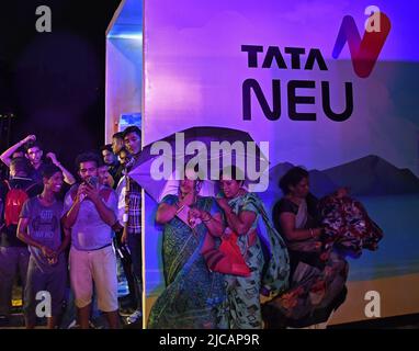 Mumbai, Indien. 11.. Juni 2022. Menschen, die neben dem Logo von „Tata Neu“ in Mumbai zu sehen sind. Werbeveranstaltung von Tata Neu, einer Online-App, die für Käufer entwickelt wurde, um den Einkauf aller Tata-Produkte auf einer Plattform zu erleben. (Foto von Ashish Vaishnav/SOPA Images/Sipa USA) Quelle: SIPA USA/Alamy Live News Stockfoto