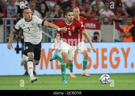 Budapest. 11.. Juni 2022. Der deutsche David Raum (L) spielt mit dem ungarischen Adam Nagy während der UEFA Nations League Ein Fußballspiel zwischen Ungarn und Deutschland am 11. Juni 2022 im Stadion der Puskas Arena in Budapest, Ungarn. Quelle: Attila Volgyi/Xinhua/Alamy Live News Stockfoto